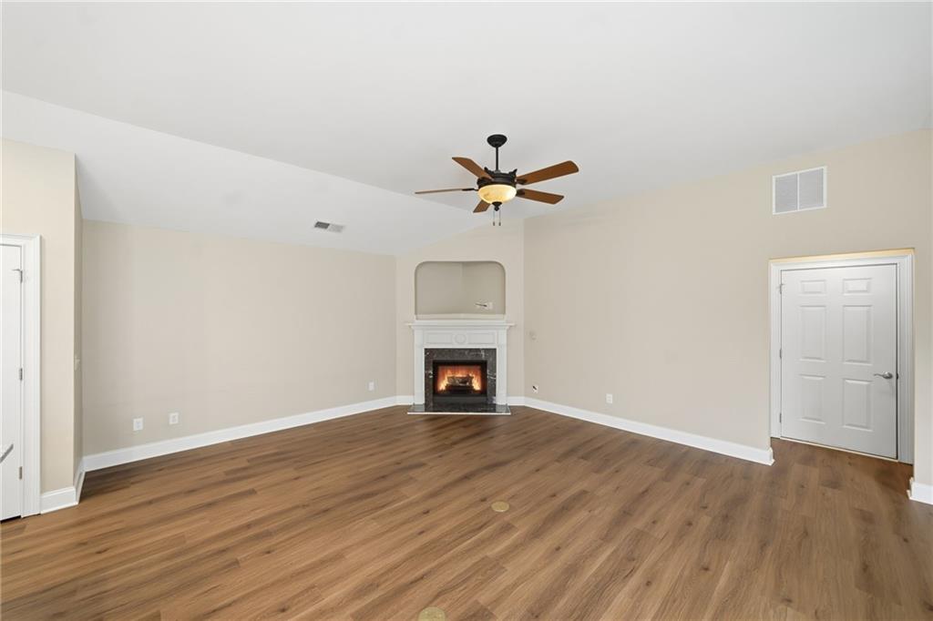 309 Jessica Way Canton, GA 30114 - Photo 3 of 27 a view of a livingroom with a fireplace and wooden floor