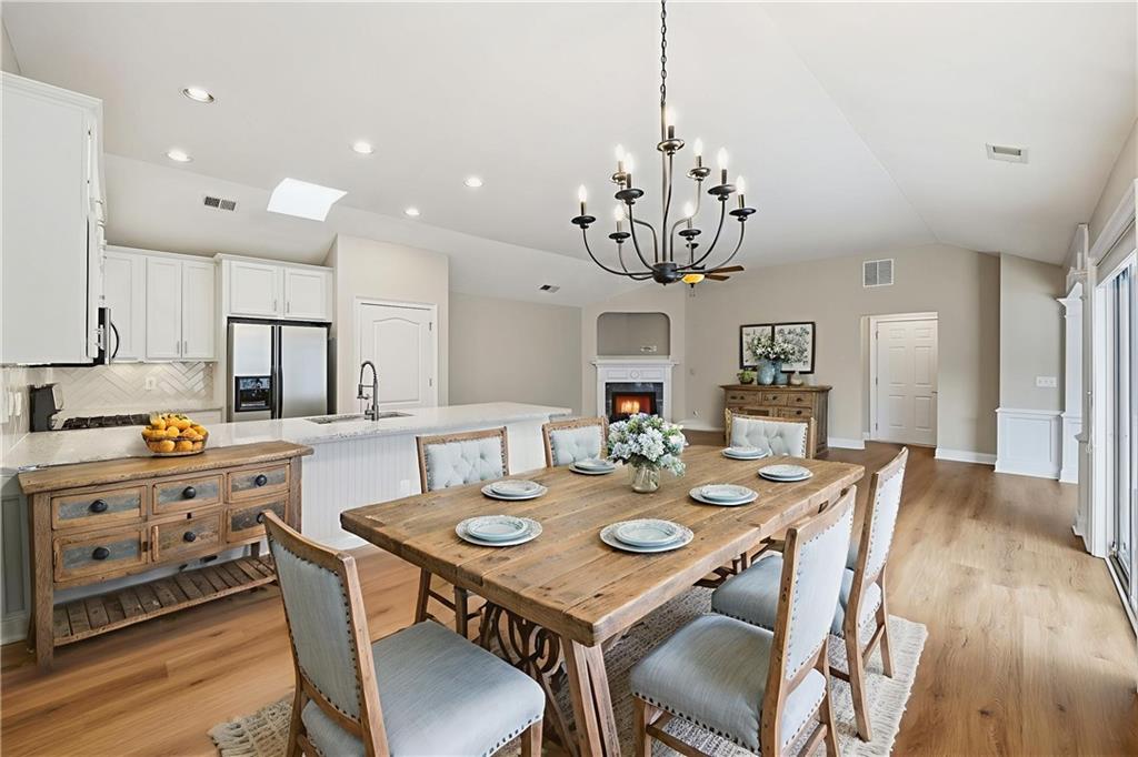 309 Jessica Way Canton, GA 30114 - Photo 4 of 27 a view of a dining room with furniture a chandelier and wooden floor
