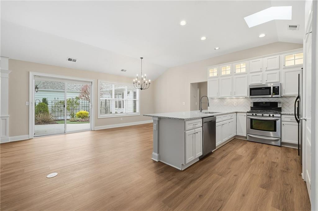 309 Jessica Way Canton, GA 30114 - Photo 5 of 27 a large kitchen with stainless steel appliances granite countertop a stove and a sink