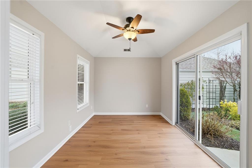 309 Jessica Way Canton, GA 30114 - Photo 10 of 27 a view of an empty room with wooden floor and a window
