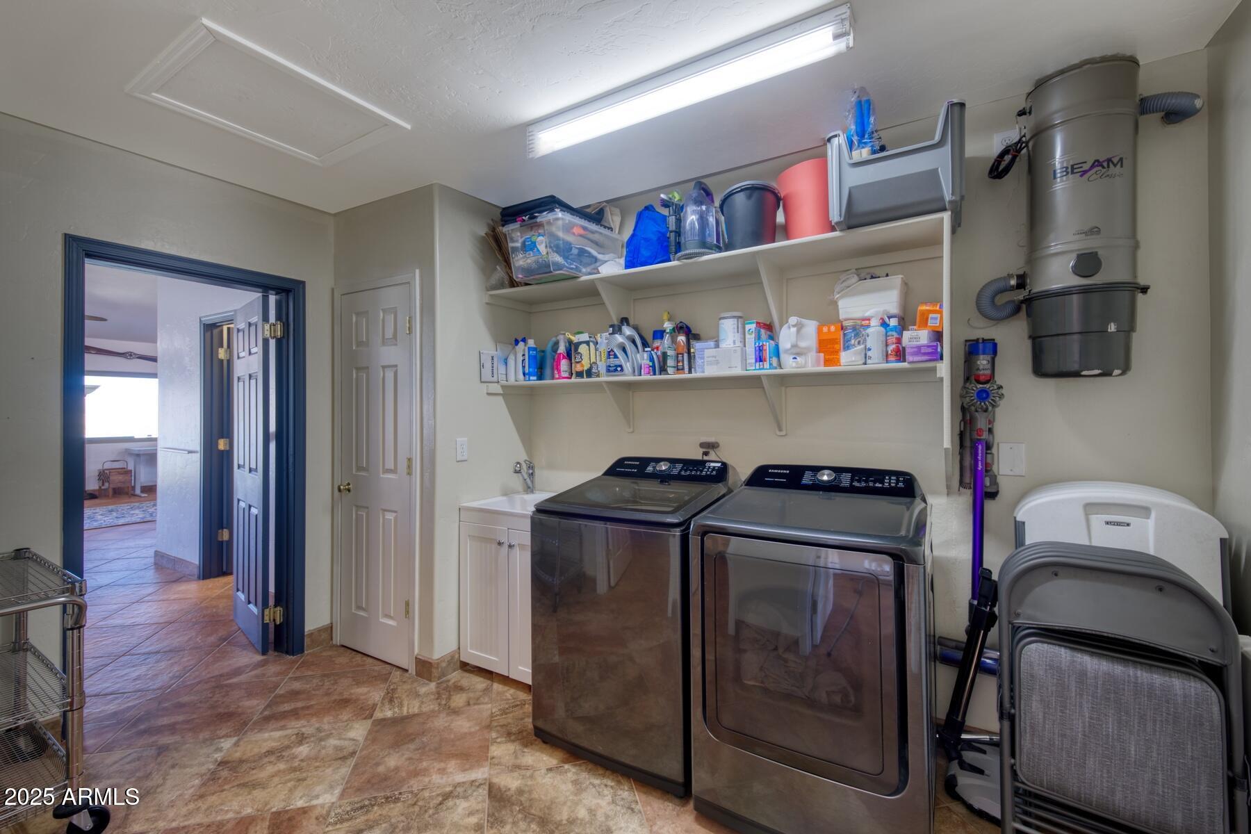 3298 West Monte Vista Trail Benson, AZ 85602 - Photo 16 of 44 a utility room with dryer washer and closet