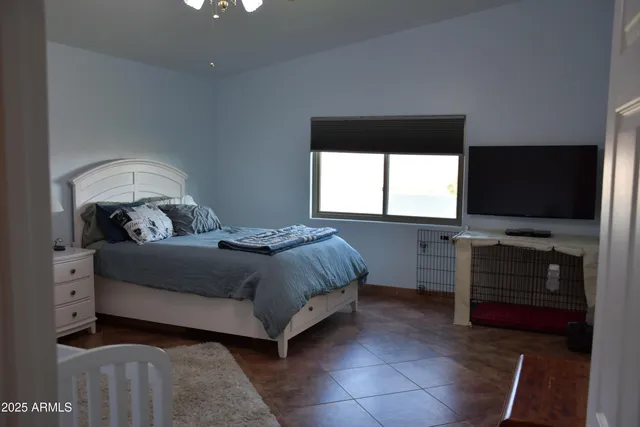 a bathroom with a granite countertop sink a large mirror and a bathtub