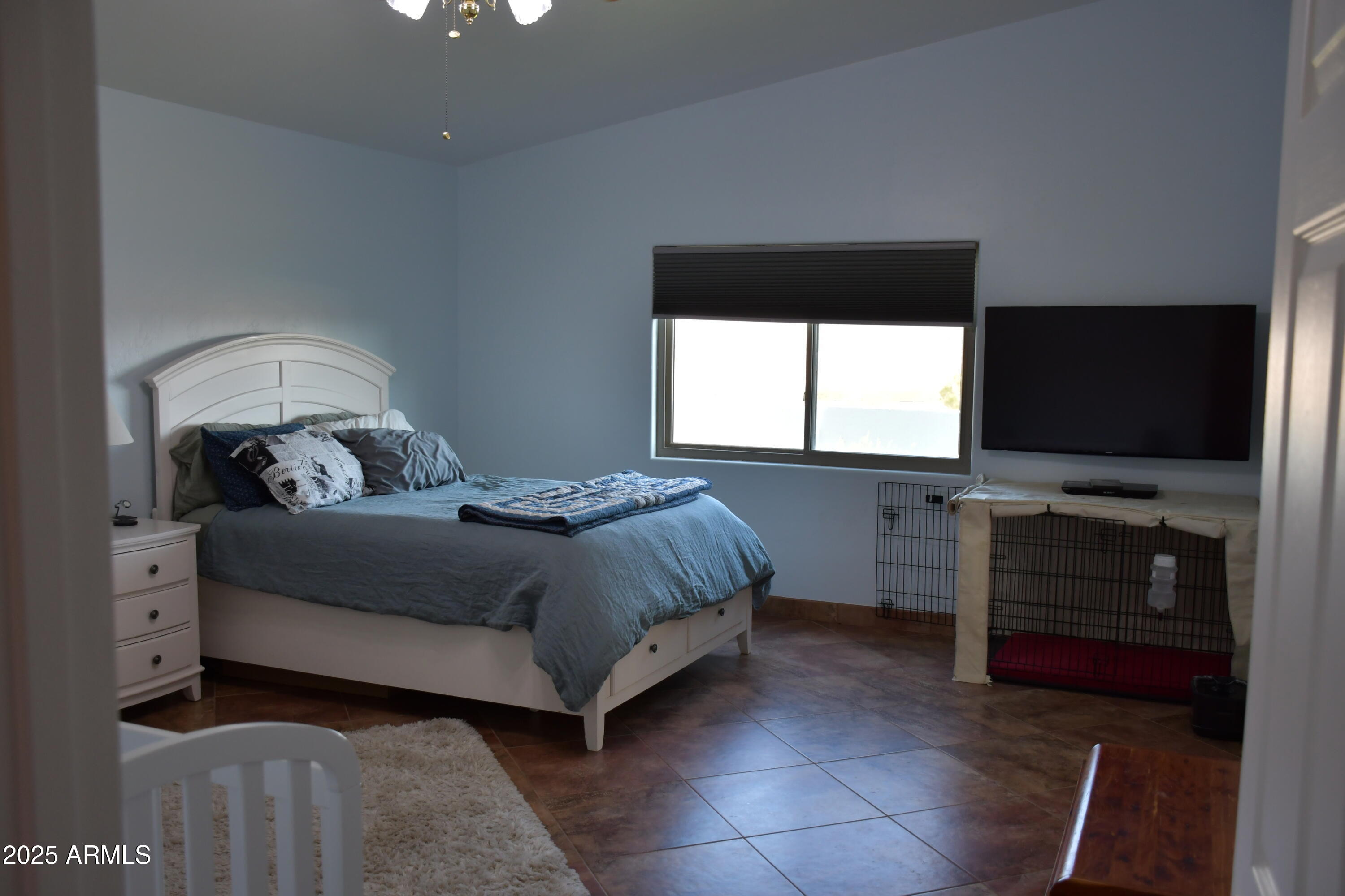 3298 West Monte Vista Trail Benson, AZ 85602 - Photo 19 of 44 a bedroom with a bed and a flat tv screen on dresser