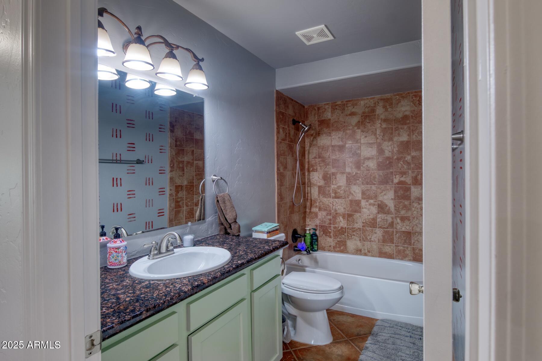 3298 West Monte Vista Trail Benson, AZ 85602 - Photo 26 of 44 a bathroom with a granite countertop sink toilet and shower