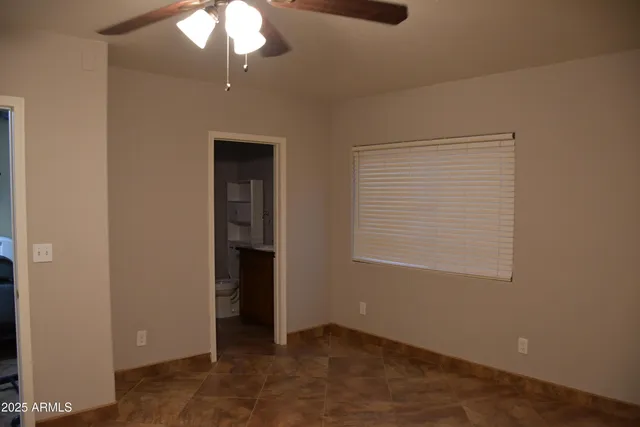a bathroom with a granite countertop sink a toilet a mirror and shower