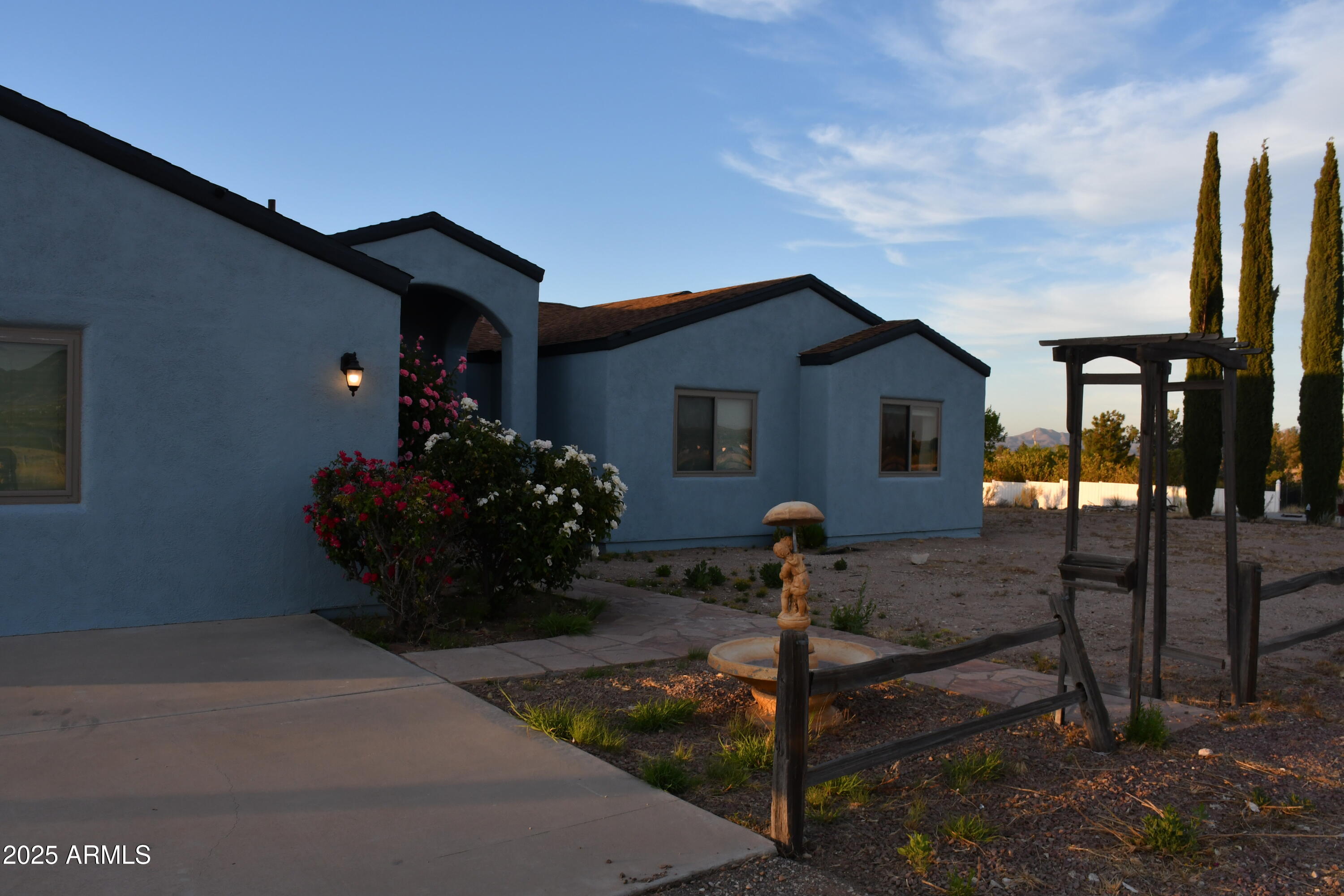 3298 West Monte Vista Trail Benson, AZ 85602 - Photo 3 of 44 a front view of a house with garden