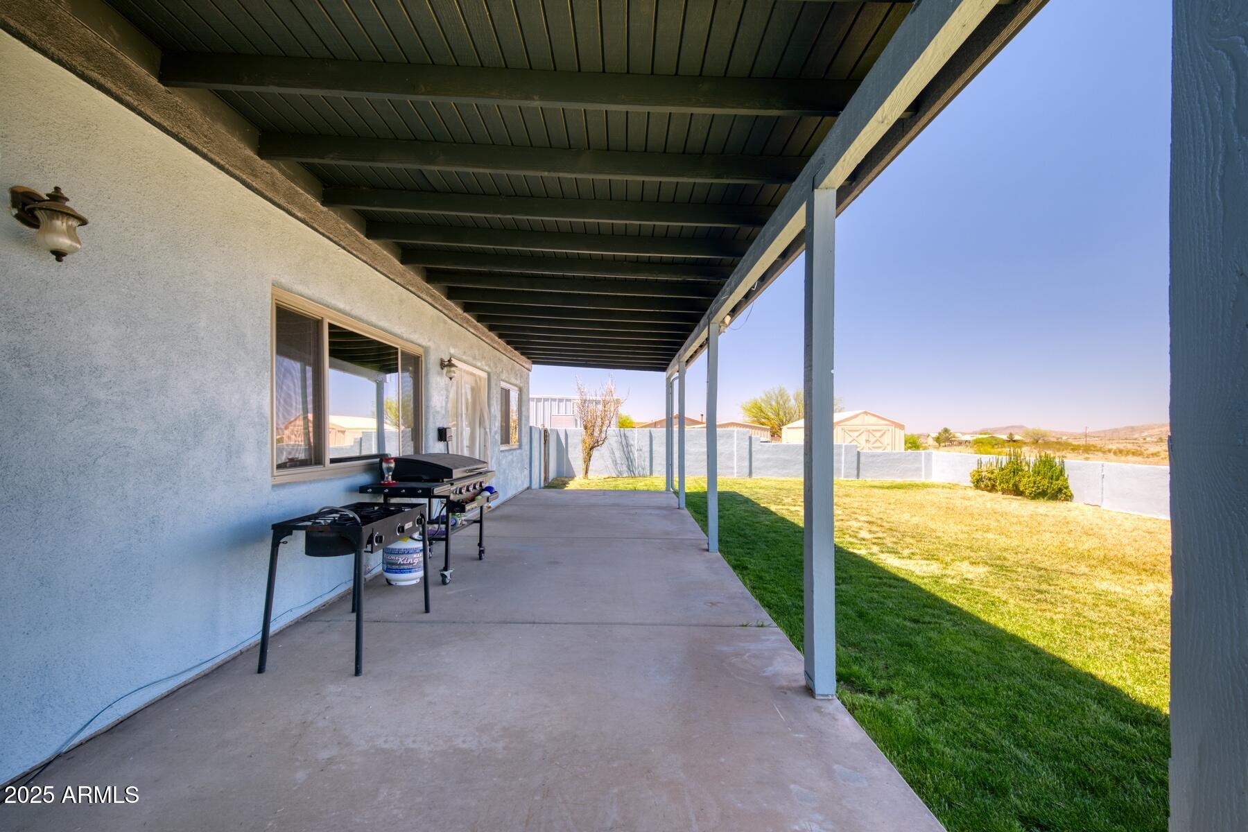 3298 West Monte Vista Trail Benson, AZ 85602 - Photo 31 of 44 a view of a porch with furniture and a yard