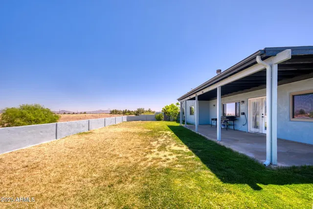 a view of a house with a yard and mountain
