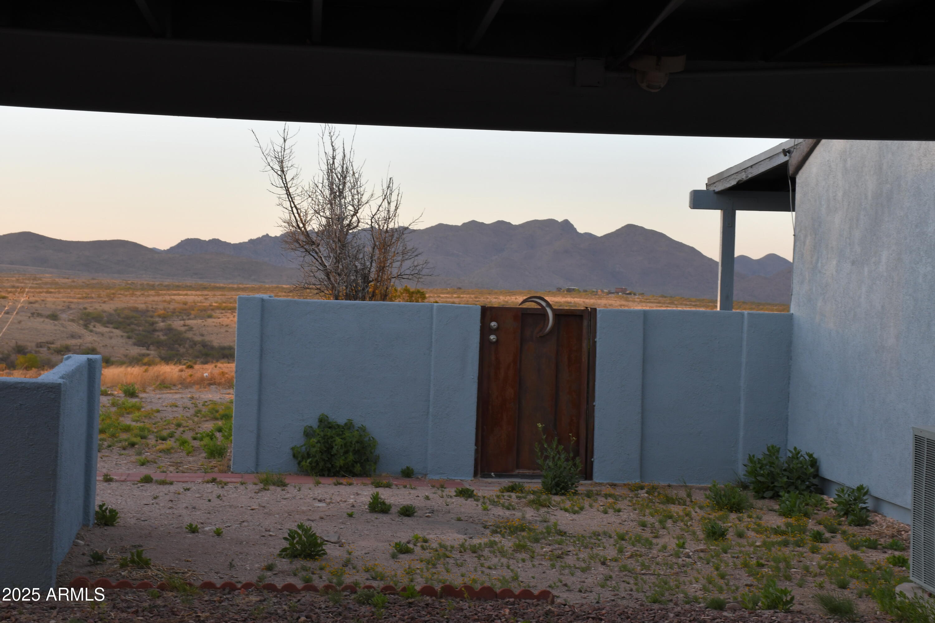 3298 West Monte Vista Trail Benson, AZ 85602 - Photo 34 of 44 a view of a house with a yard and mountain
