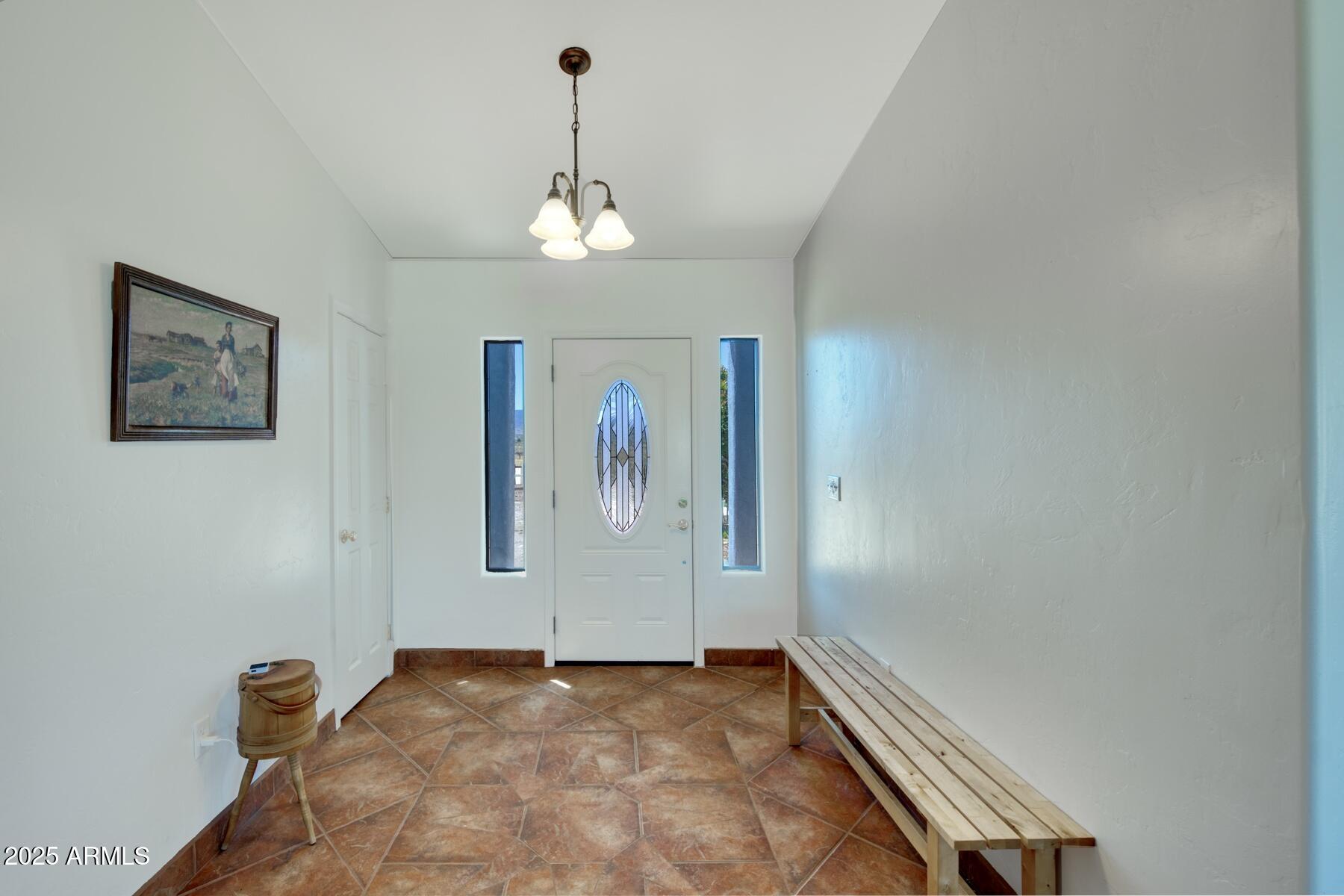3298 West Monte Vista Trail Benson, AZ 85602 - Photo 6 of 44 a view of a hallway with a chandelier