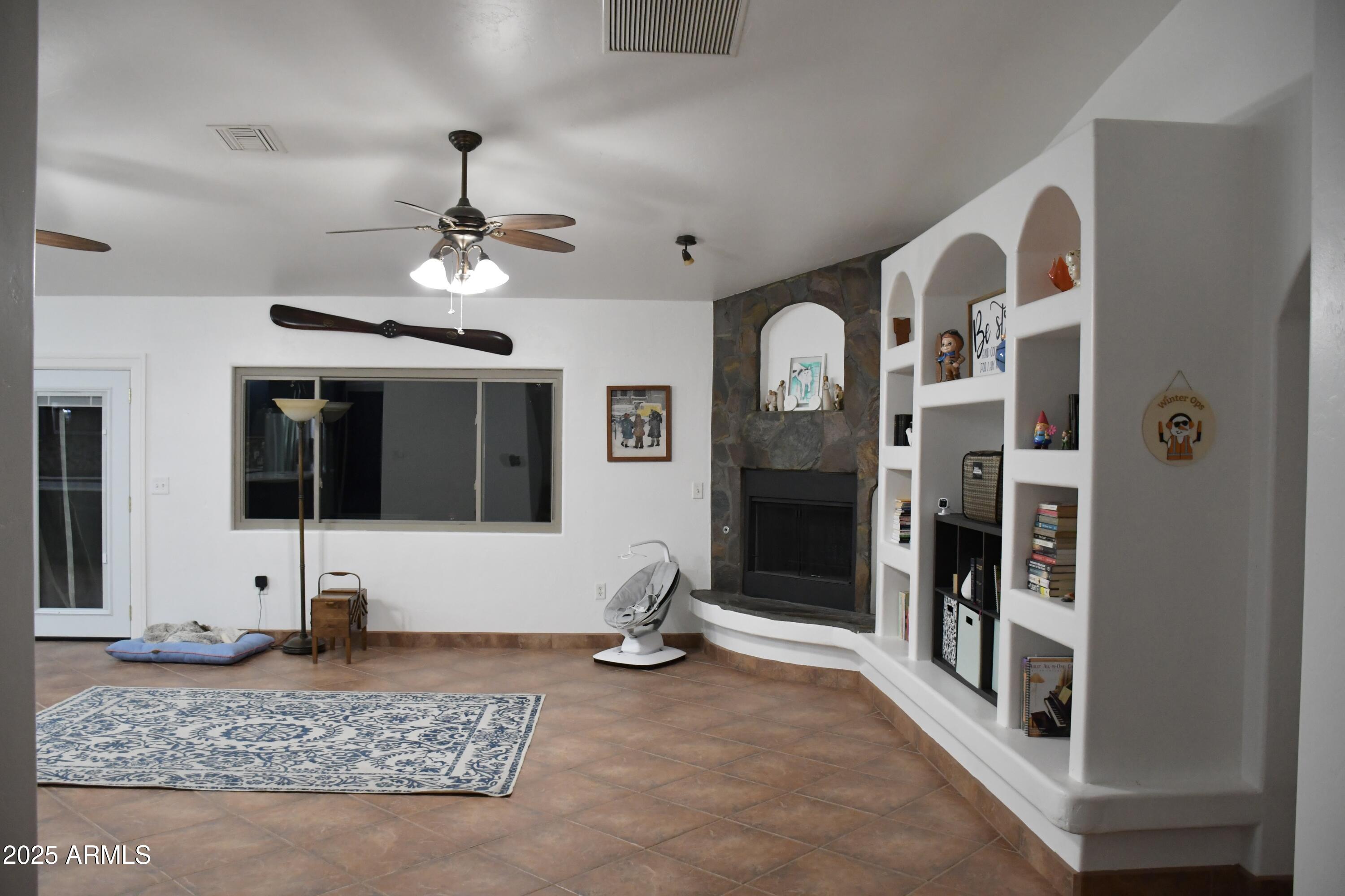 3298 West Monte Vista Trail Benson, AZ 85602 - Photo 7 of 44 a view of a hallway with dining area and chandelier