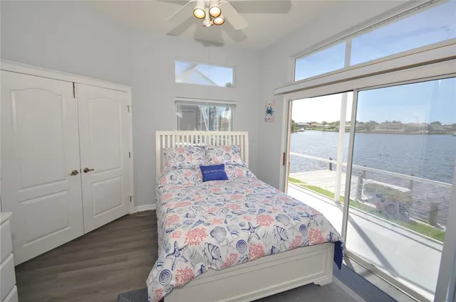 a view of a bedroom with a bed and wooden floor