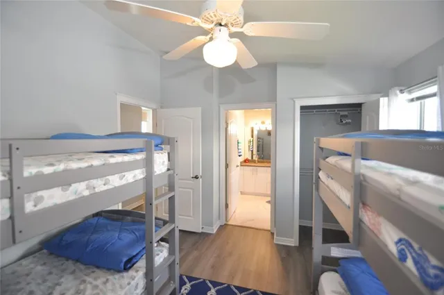 a front view of a house with a yard and potted plants