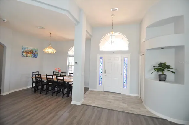 a living room with furniture window and wooden floor