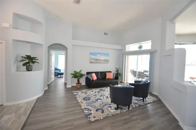 a dining room with furniture and a floor to ceiling window