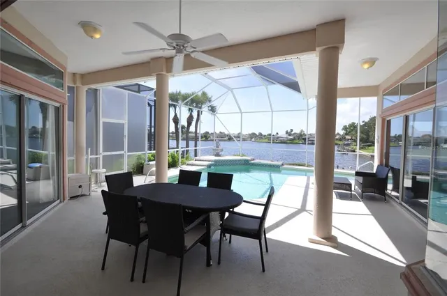 a living room with furniture two window and wooden floor