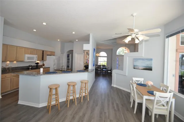 a large kitchen with a table and chairs
