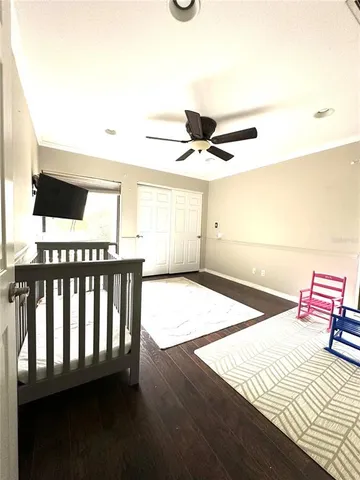 a bedroom with a bed and a large mirror