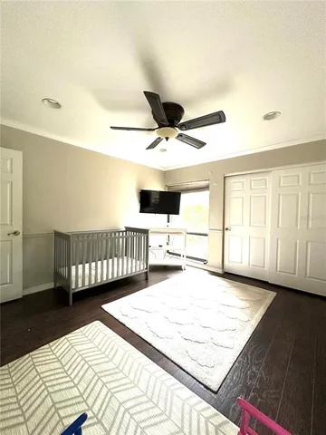 a bedroom with a large bed and a large window