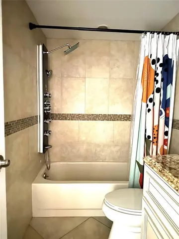 a bedroom with a large bed and a flat screen tv