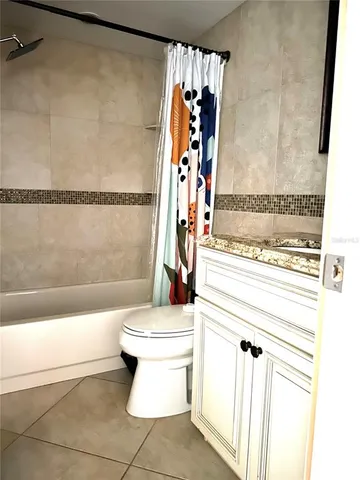 a bedroom with a bed and a night stand