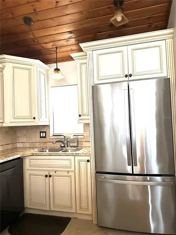 a kitchen with a stove and a white cabinets