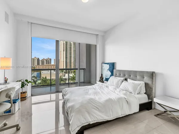 a bedroom with a bed and a large window