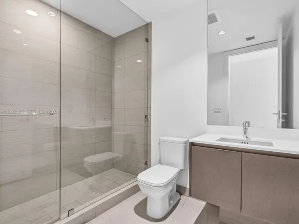 a bathroom with a toilet sink and shower