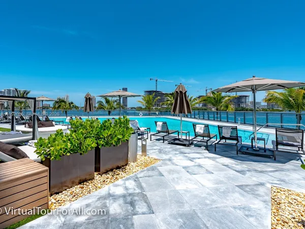 a view of swimming pool with outdoor seating and yard