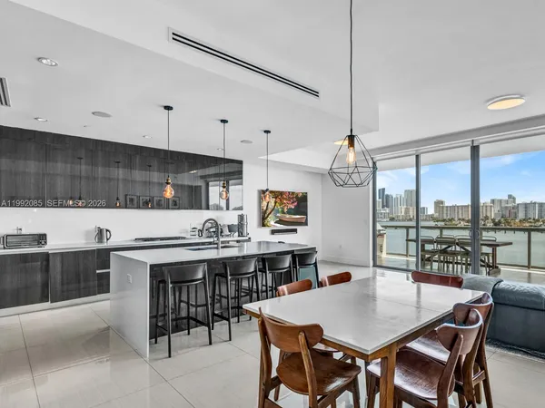 a kitchen with a stove a table and chairs in it