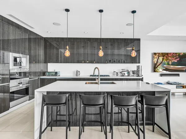 a kitchen with a table chairs sink and cabinets