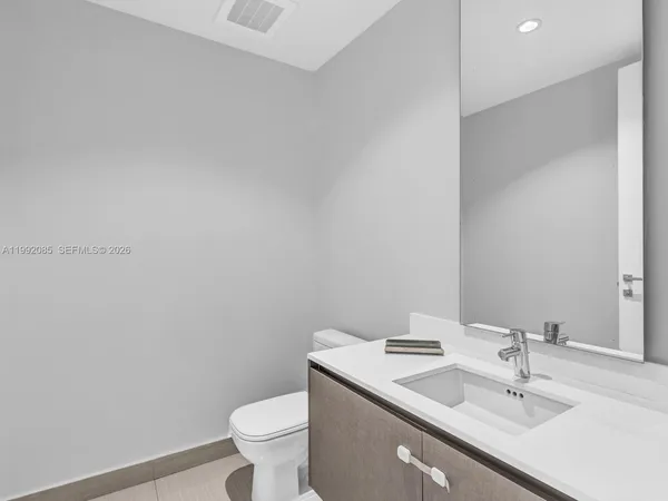 a bathroom with a sink toilet and a mirror