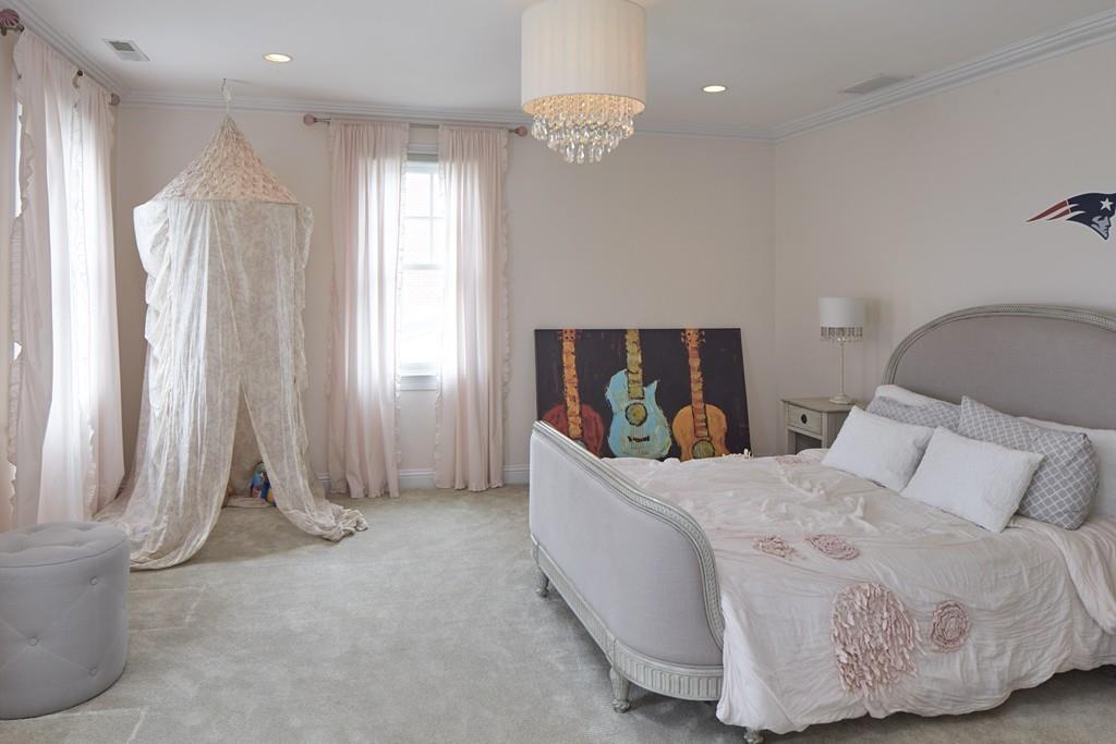 80 Stockdale Road Needham, MA 02492 - Photo 13 of 20 a bedroom with a bed and a chandelier