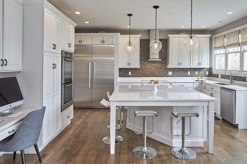 80 Stockdale Road Needham, MA 02492 - Photo 4 of 20 a kitchen with stainless steel appliances granite countertop a kitchen island hardwood floor and a sink