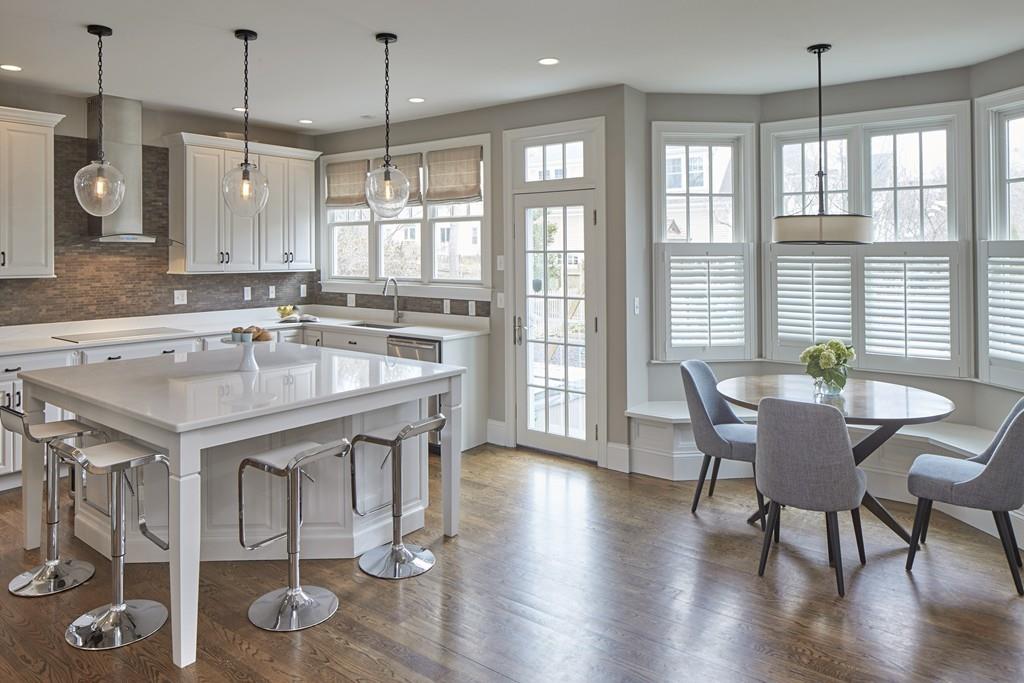 80 Stockdale Road Needham, MA 02492 - Photo 5 of 20 a kitchen with granite countertop a table chairs stove and wooden floor