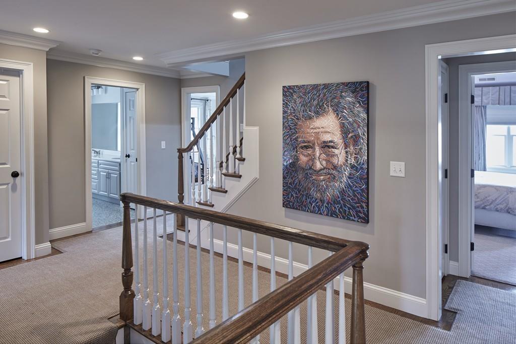 80 Stockdale Road Needham, MA 02492 - Photo 10 of 20 a view of staircase with lots of frames on wall and wooden floor
