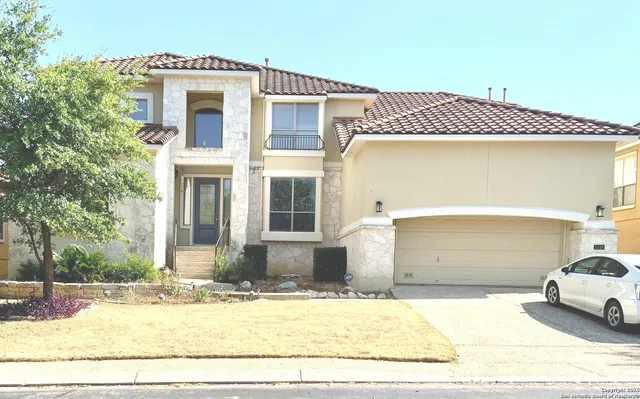 a view of a house with a wooden fence