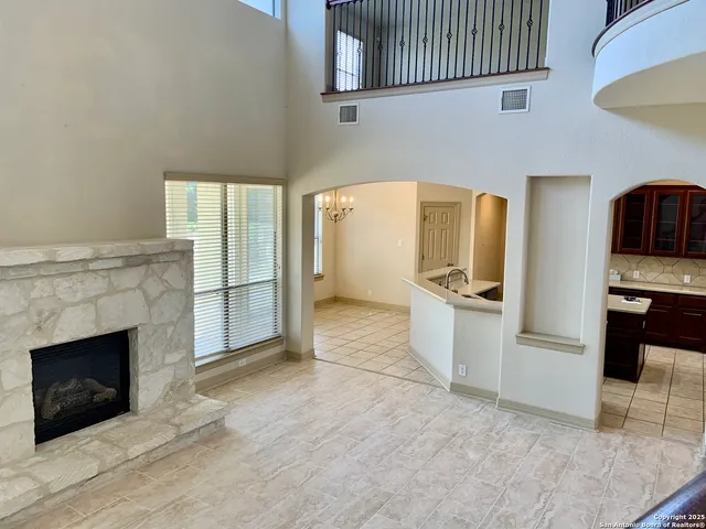 a view of a kitchen with a sink cabinets and a fireplace
