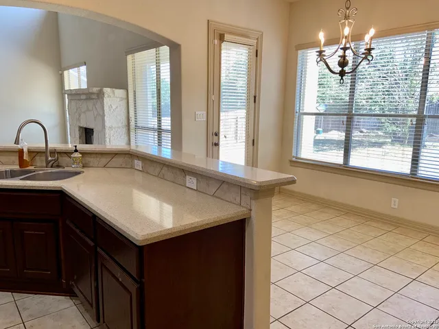 a kitchen with stainless steel appliances granite countertop a sink and a refrigerator