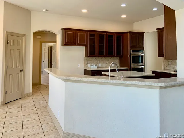 a kitchen with stainless steel appliances granite countertop a sink counter space and a window