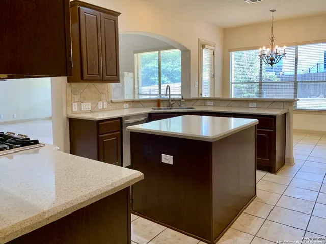 a kitchen with a sink and a refrigerator