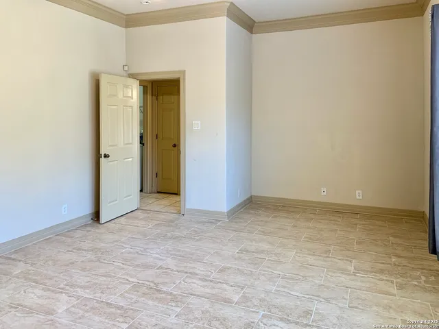 an empty room with closet and bathroom