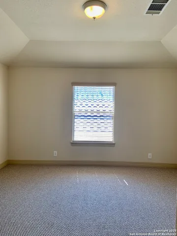 a view of room with a ceiling fan and window