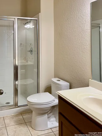a view of an empty room with a fireplace and a window