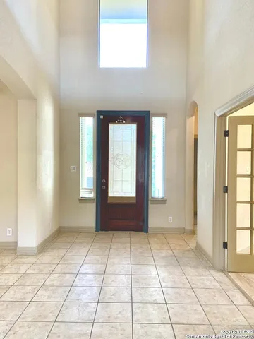 a view of an empty room with window and bathroom