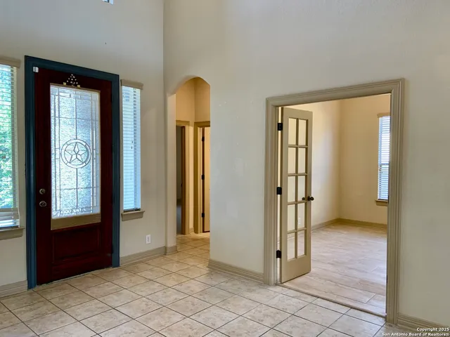 an empty room with windows and closet