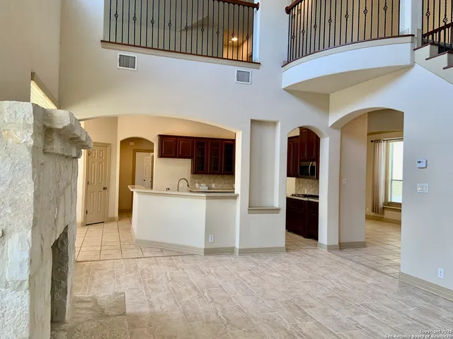 a view of a hallway with entryway and kitchen view