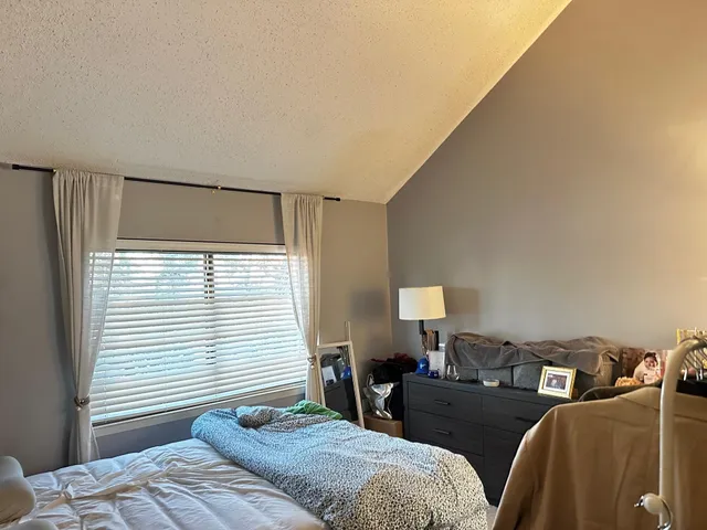 a bedroom with a bed and a window