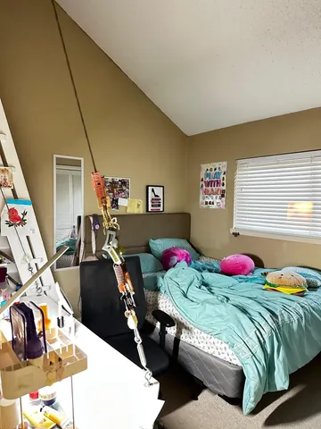 a living room with couches and a dining table with wooden floor
