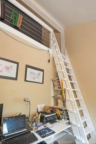 a bedroom with a bed and a shelf